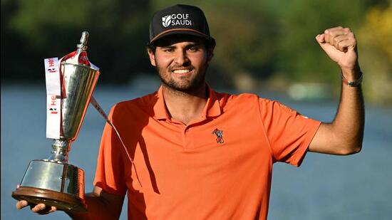 Eugenio Chaparra posing with trophy after winning Hero Indian Open